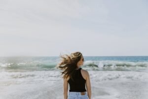 Brandi Loge standing in front of the beach