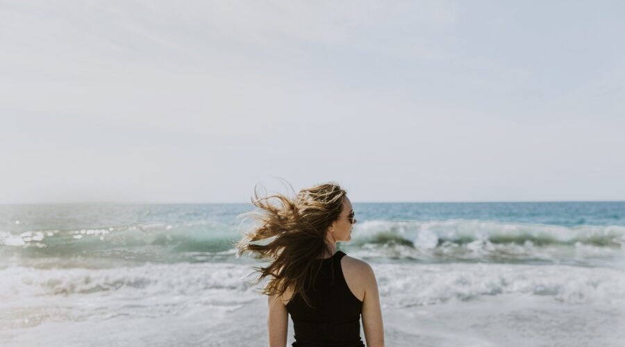 Brandi Loge standing in front of the beach