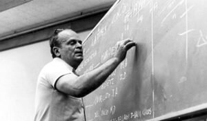 César Lattes writting something on board