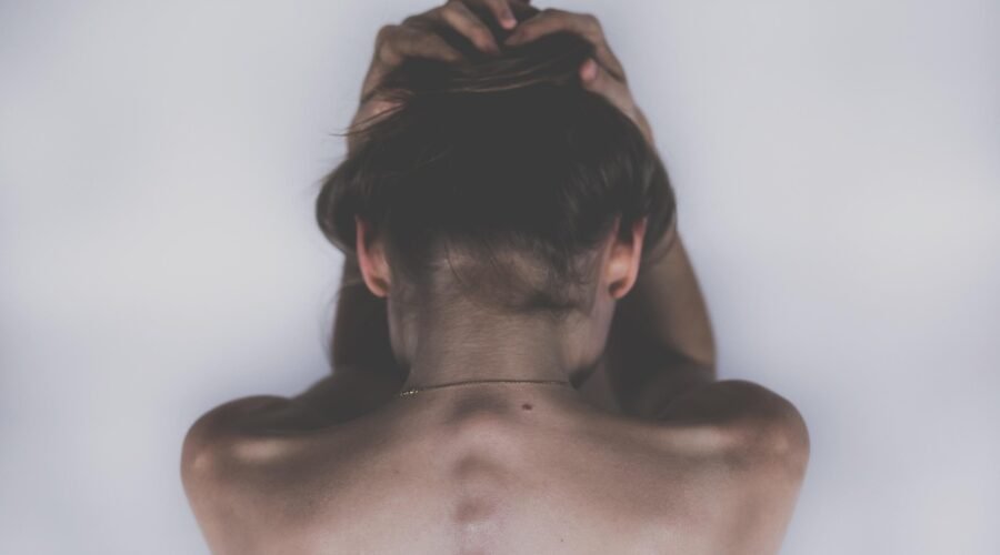 A women is facing down with her face showing her back because of Inomyalgia