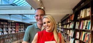 Martin Lewis standing with a girl